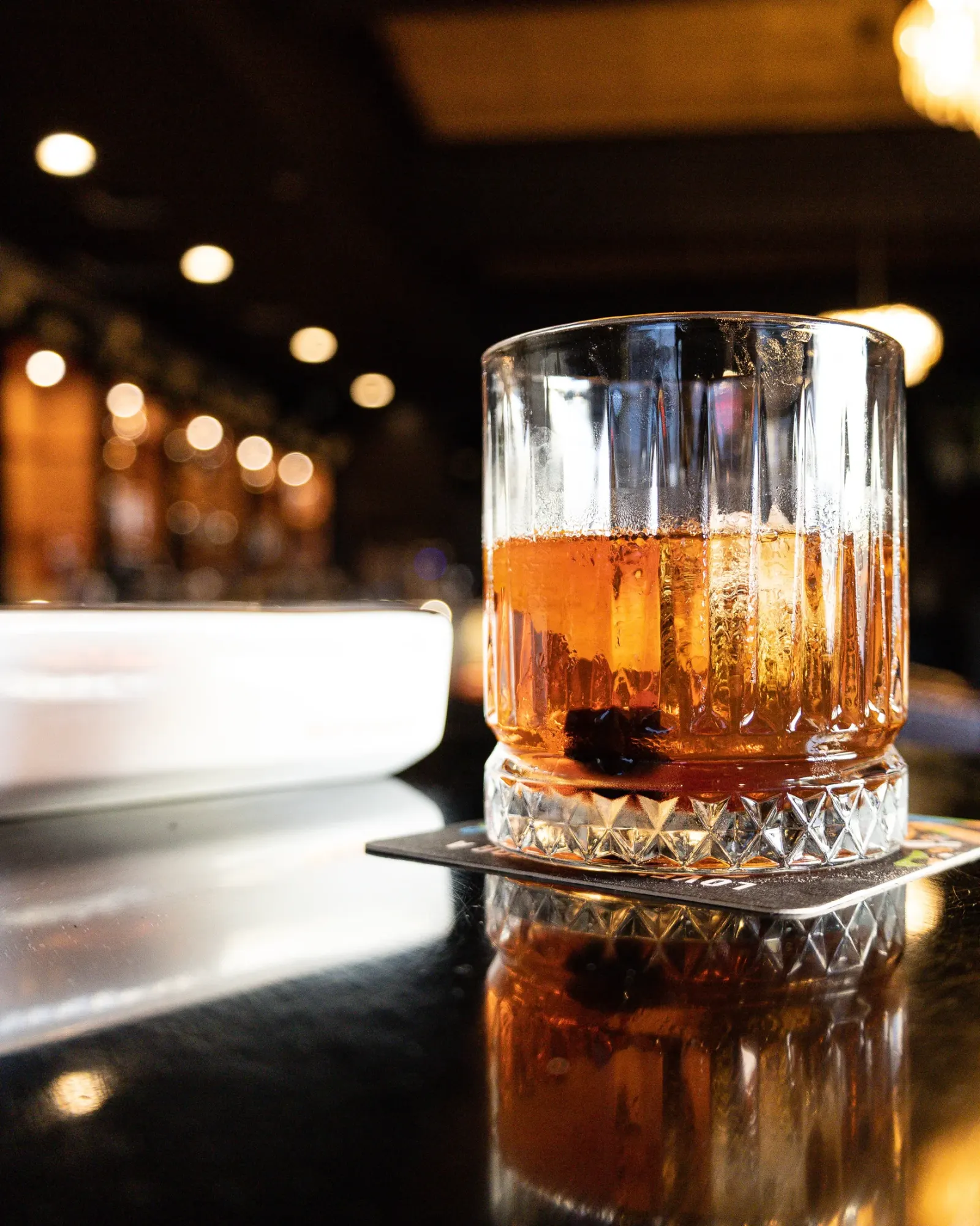 A whiskey cocktail poured at Sigaro